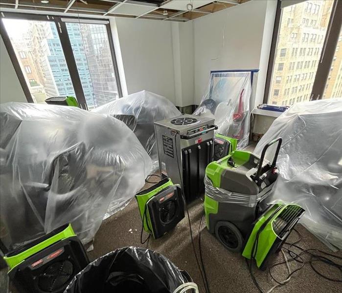 Drying equipment is setup in a crowded commercial space.